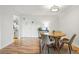 Bright dining area with a round wooden table, seating for four, and hardwood flooring at 888 N Logan St # 5A, Denver, CO 80203