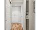 Bright hallway with hardwood floors, leading to storage and kitchen areas, creating a seamless flow within the home at 888 N Logan St # 5A, Denver, CO 80203