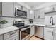 Updated kitchen with stainless steel appliances, white cabinets, and white subway tile backsplash at 888 N Logan St # 5A, Denver, CO 80203