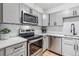 Well-lit kitchen with modern appliances, stylish cabinets, and ample counter space at 888 N Logan St # 5A, Denver, CO 80203