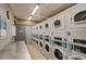 On-site laundry room with multiple washers and dryers, offering convenience for residents at 888 N Logan St # 5A, Denver, CO 80203