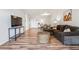 Bright living room with wood floors, comfortable seating, and a view into the kitchen and dining area at 888 N Logan St # 5A, Denver, CO 80203