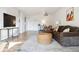 Open-concept living area with a brown sectional, a large flat screen, hardwood floors, and space for a dining table at 888 N Logan St # 5A, Denver, CO 80203