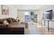 Comfortable living room with hardwood flooring, a plush sectional sofa, and a sliding glass door to a balcony at 888 N Logan St # 5A, Denver, CO 80203