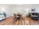 Inviting living room featuring a round table, sleek hardwood floors, and cozy seating at 888 N Logan St # 5A, Denver, CO 80203