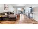 Bright living room with wood floors, comfortable seating, and a sliding glass door leading to a balcony at 888 N Logan St # 5A, Denver, CO 80203