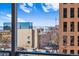 Bright view from the balcony showing the city skyline and distant mountains at 888 N Logan St # 5A, Denver, CO 80203