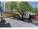 Backyard featuring an expansive deck with a picnic table, shaded by mature trees at 1315 Gaylord St, Denver, CO 80206