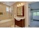 Bright bathroom featuring a classic vanity with a marble countertop and a tiled shower-over-tub at 1315 Gaylord St, Denver, CO 80206