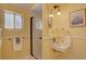 Charming yellow bathroom featuring a unique sink and shower with sleek glass doors at 1315 Gaylord St, Denver, CO 80206