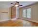 Light-filled bedroom with hardwood floors, double windows, and a decorative brick wall at 1315 Gaylord St, Denver, CO 80206