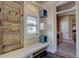 Inviting entryway with a custom bench, storage cubes, and a weathered wood door at 1315 Gaylord St, Denver, CO 80206