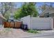 Detached garage with a white door and fenced-in parking area at 1315 Gaylord St, Denver, CO 80206
