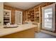 Kitchen with exposed brick, wooden shelves, farmhouse sink, and stainless steel appliances at 1315 Gaylord St, Denver, CO 80206