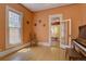 Light-filled room featuring hardwood floors, a vintage piano, and view into another room at 1315 Gaylord St, Denver, CO 80206