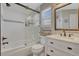 Bright bathroom featuring a shower over tub, white subway tile, and a stylish vanity at 12521 S Elk Creek Way, Parker, CO 80134