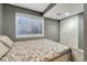 Basement bedroom featuring gray walls, a window with blinds and a double closet with doors at 12521 S Elk Creek Way, Parker, CO 80134