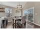 Cozy dining area with modern light fixture and sliding glass doors to the deck at 12521 S Elk Creek Way, Parker, CO 80134