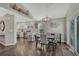 Open dining room featuring hardwood floors, modern lighting, and easy access to kitchen at 12521 S Elk Creek Way, Parker, CO 80134