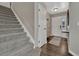 Inviting entryway showcasing staircase, coat closet, and dark hardwood floors at 12521 S Elk Creek Way, Parker, CO 80134