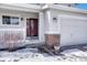 Inviting front entrance features a covered porch, brick accents, and a well-maintained two-car garage at 12521 S Elk Creek Way, Parker, CO 80134