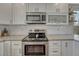 Modern kitchen with stainless steel appliances and white cabinets at 12521 S Elk Creek Way, Parker, CO 80134