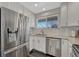 Well-lit kitchen with stainless steel appliances and white subway tile at 12521 S Elk Creek Way, Parker, CO 80134