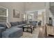 Inviting living room with a large gray sectional, hardwood floors, and plenty of natural light at 12521 S Elk Creek Way, Parker, CO 80134