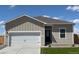 Charming single-story home boasts neutral siding, a well-manicured lawn, and an attached two-car garage at 2245 Alyssa St, Fort Lupton, CO 80621