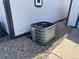 Side view of the house featuring a new AC unit and rock landscaping at 8362 Jasmine St, Commerce City, CO 80022