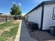 Spacious backyard view with shed, and the side of the home with new AC unit at 8362 Jasmine St, Commerce City, CO 80022