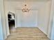 Dining room with modern chandelier and an open view to the kitchen at 8362 Jasmine St, Commerce City, CO 80022
