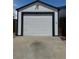 Front view of garage with new paint and garage door featuring decorative square pattern at 8362 Jasmine St, Commerce City, CO 80022