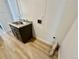 Laundry room featuring a sink with dark wood cabinets and a vent for a dryer at 8362 Jasmine St, Commerce City, CO 80022