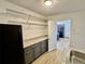Walk-in pantry with gray cabinets, granite countertops, and ample shelving at 8362 Jasmine St, Commerce City, CO 80022