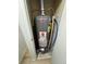 Water heater in a closet on a light plank floor with updated plumbing at 8362 Jasmine St, Commerce City, CO 80022