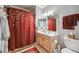 Well-lit bathroom with a vanity, large mirror, and decorative shower curtain at 10007 Martin Luther King Blvd # 104, Denver, CO 80238