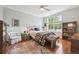 Cozy bedroom with a large window, hardwood floors, and a comfortable seating area at 10007 Martin Luther King Blvd # 104, Denver, CO 80238