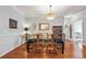 Elegant dining room featuring hardwood floors, stylish lighting, and a glass table at 10007 Martin Luther King Blvd # 104, Denver, CO 80238
