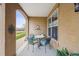 Inviting front porch showcasing an outdoor dining set, decor, and view of surrounding landscape at 10007 Martin Luther King Blvd # 104, Denver, CO 80238