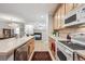 Open kitchen featuring a breakfast bar and updated appliances at 10007 Martin Luther King Blvd # 104, Denver, CO 80238