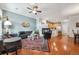 Open-concept living area with fireplace, ceiling fan, and view of kitchen and dining areas at 10007 Martin Luther King Blvd # 104, Denver, CO 80238