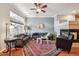 Inviting living room featuring a fireplace, ceiling fan, stylish rug, and ample natural light at 10007 Martin Luther King Blvd # 104, Denver, CO 80238