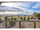 Back deck featuring wood railing and expansive views of the surrounding landscape with green trees at 1012 S Addison Way, Aurora, CO 80018