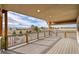 Open back deck with wood railing featuring sweeping views of green trees and the sprawling rural landscape at 1012 S Addison Way, Aurora, CO 80018