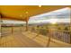 Wooden back deck featuring a wood railing and sweeping views of the surrounding landscape at sunset at 1012 S Addison Way, Aurora, CO 80018