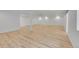 This finished basement features wood-look floors and bright lighting, a blank canvas for your dream space at 1012 S Addison Way, Aurora, CO 80018