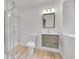 Modern bathroom features a glass-enclosed shower, a sleek vanity, and wood-look tile floors at 1012 S Addison Way, Aurora, CO 80018
