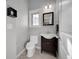 Cozy powder room featuring modern fixtures, wood vanity, and neutral paint tones at 1012 S Addison Way, Aurora, CO 80018