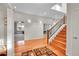Bright foyer with hardwood floors, staircase, and views into the living spaces, creating a welcoming entrance at 1012 S Addison Way, Aurora, CO 80018